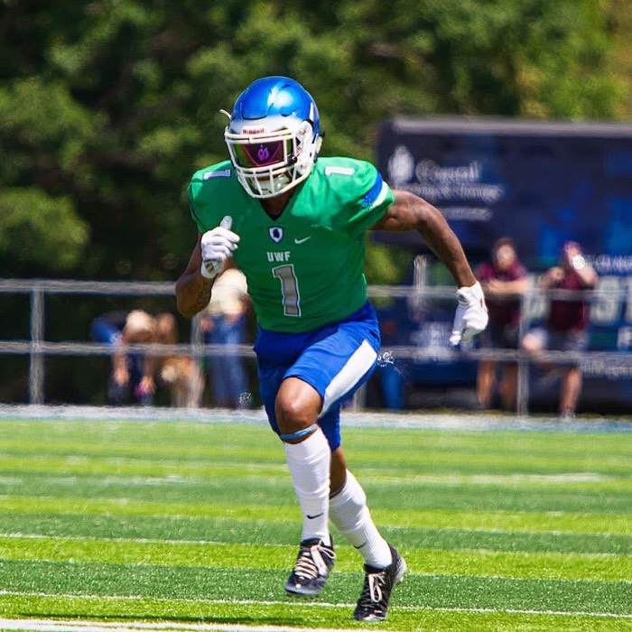 Hiram Velez running a route in a West Florida uniform.