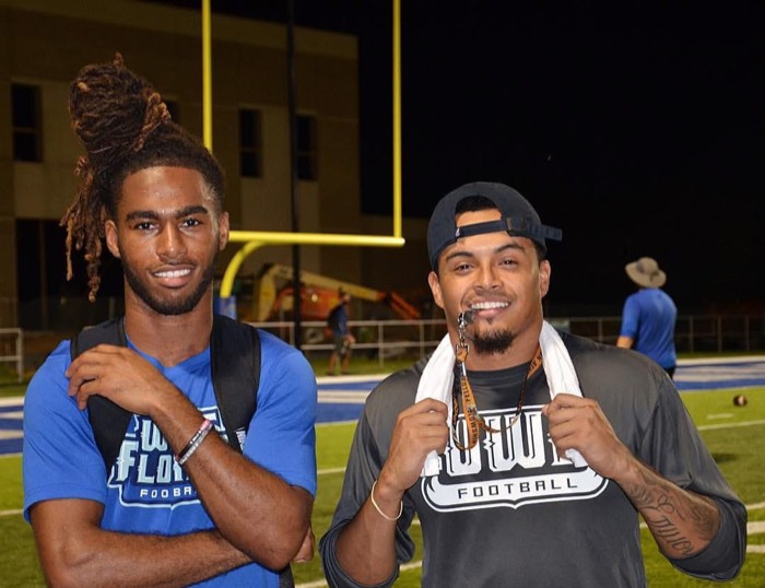 Hiram Velez on the field with a teammate after a night practice.